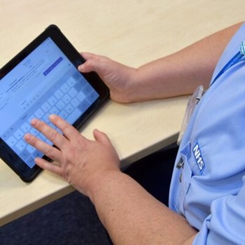 Staff member using a tablet device