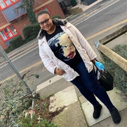 A picture of Gloria standing outside