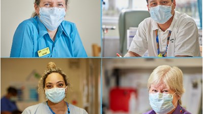 Photo of four clinicians smiling while working