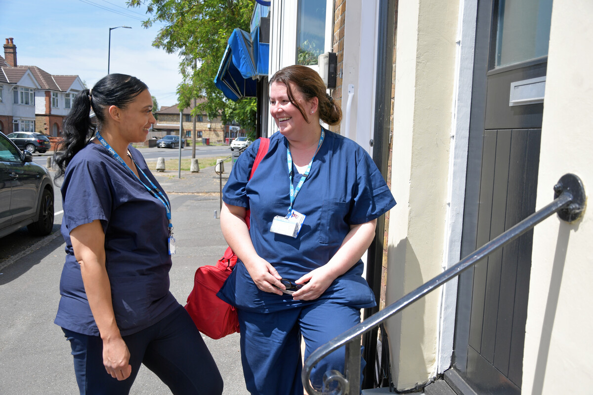 Two junior doctors talking to each other outside