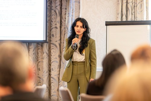 Holly Dale talking to the group using a microphone