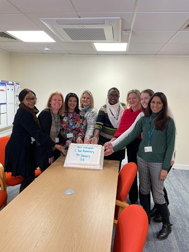 MHICS Wokingham team posing with their anniversary cake
