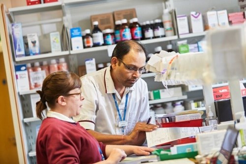 A picture of two staff members working in our pharmacy