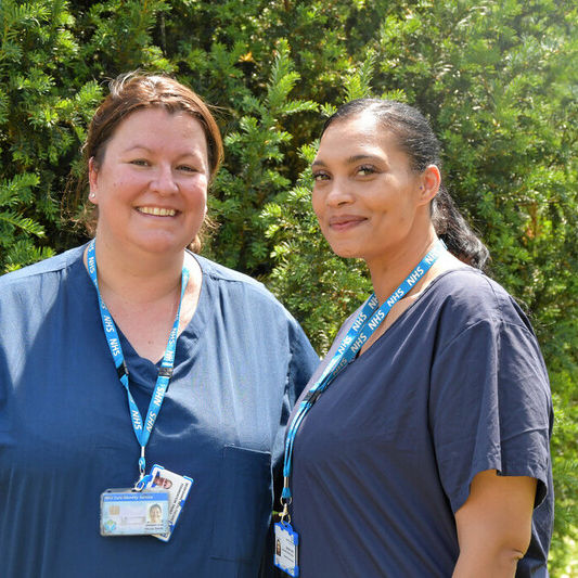 Two nurses outside smiling