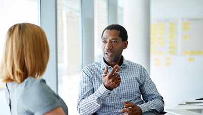 Image of two people having a conversation