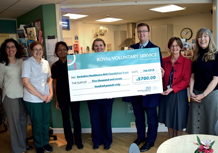 Staff and volunteers holding the cheque