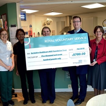 Staff and volunteers holding the cheque