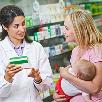 A pharmacist assisting a parent with a small child