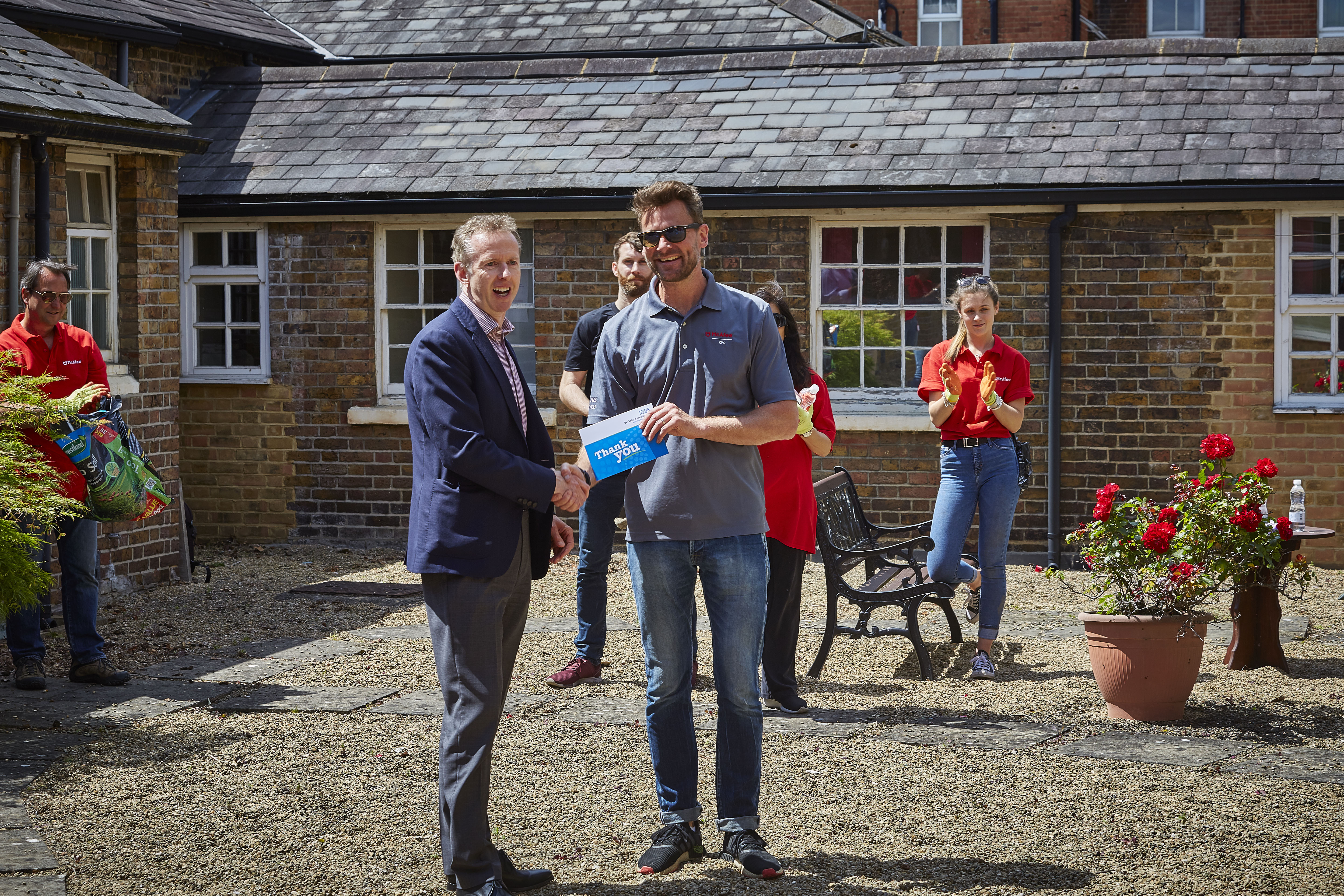 CEO Julian Emms presenting Adam Philpott with a thank you card.
