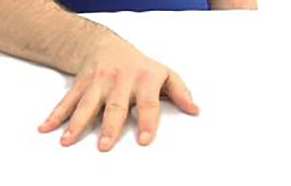 Hand on table at an angle from the wrist.
