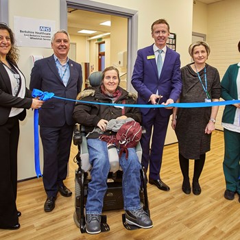 Our CEO Julian Emms with staff and patients cutting the official opening ribbon