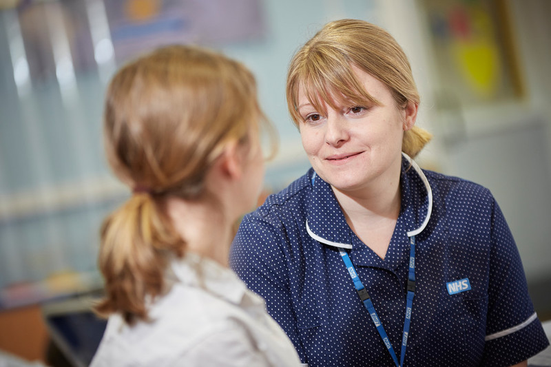 A care professional talking to a young person