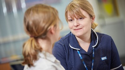 A care professional talking to a young person