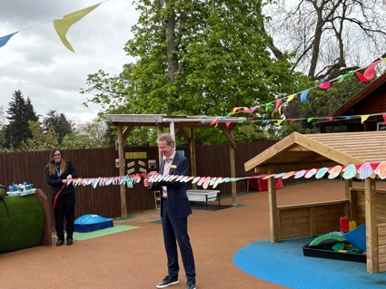 Julian cutting the ribbon in the nursery outdoor space