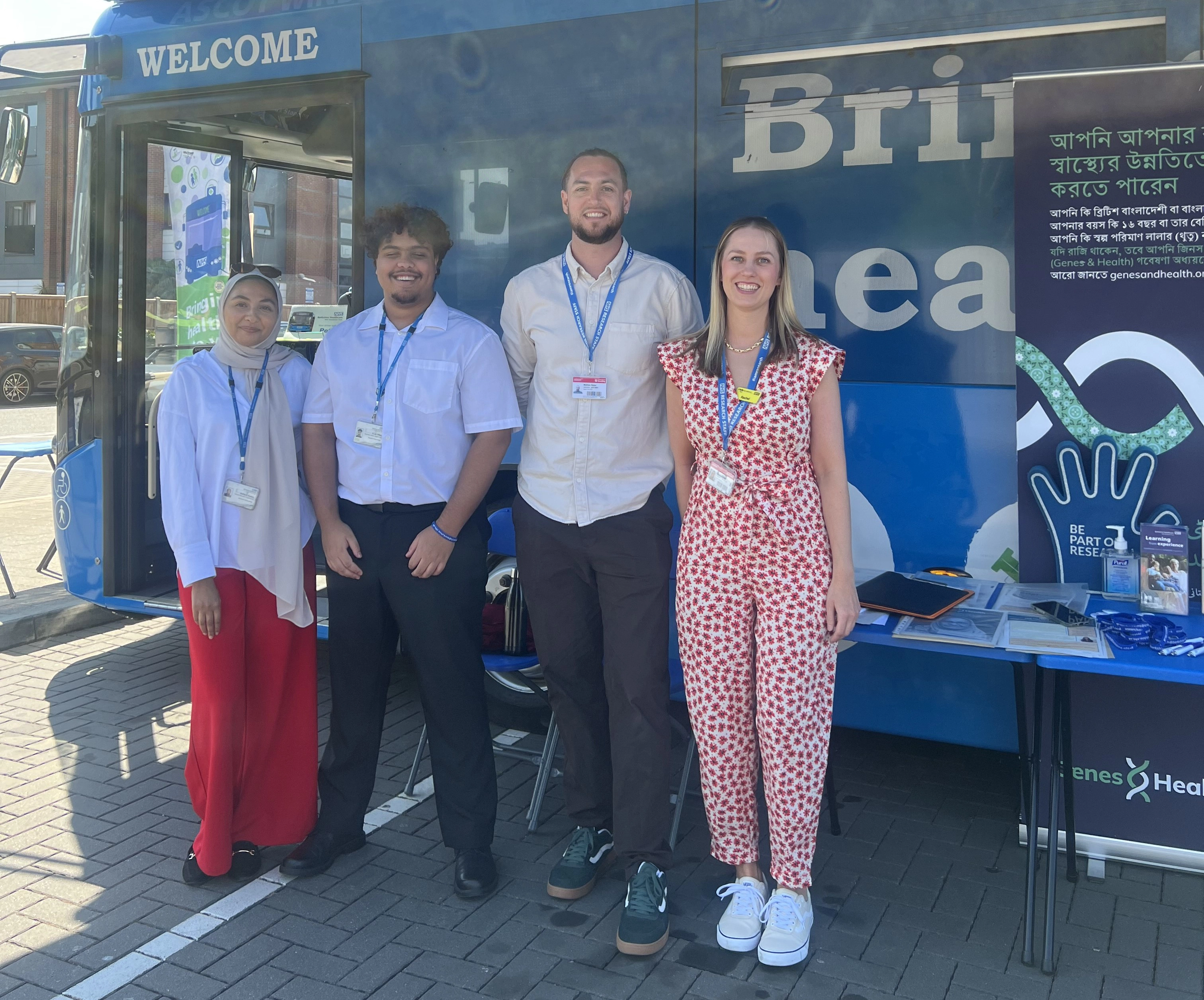 Clinical Research And Development Team Photo four team members outside health bus