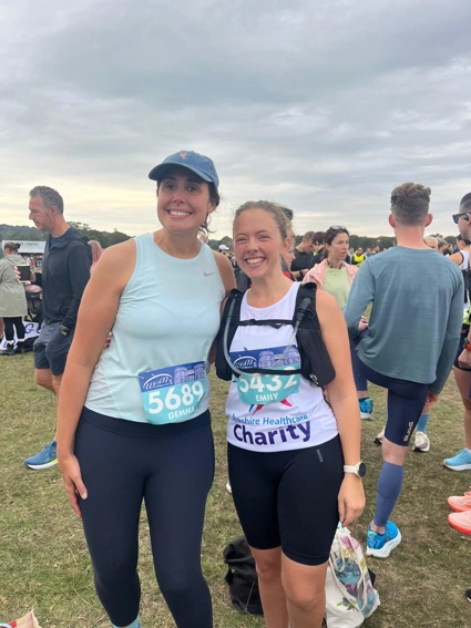 Two team members smiling after finishing the triathlon