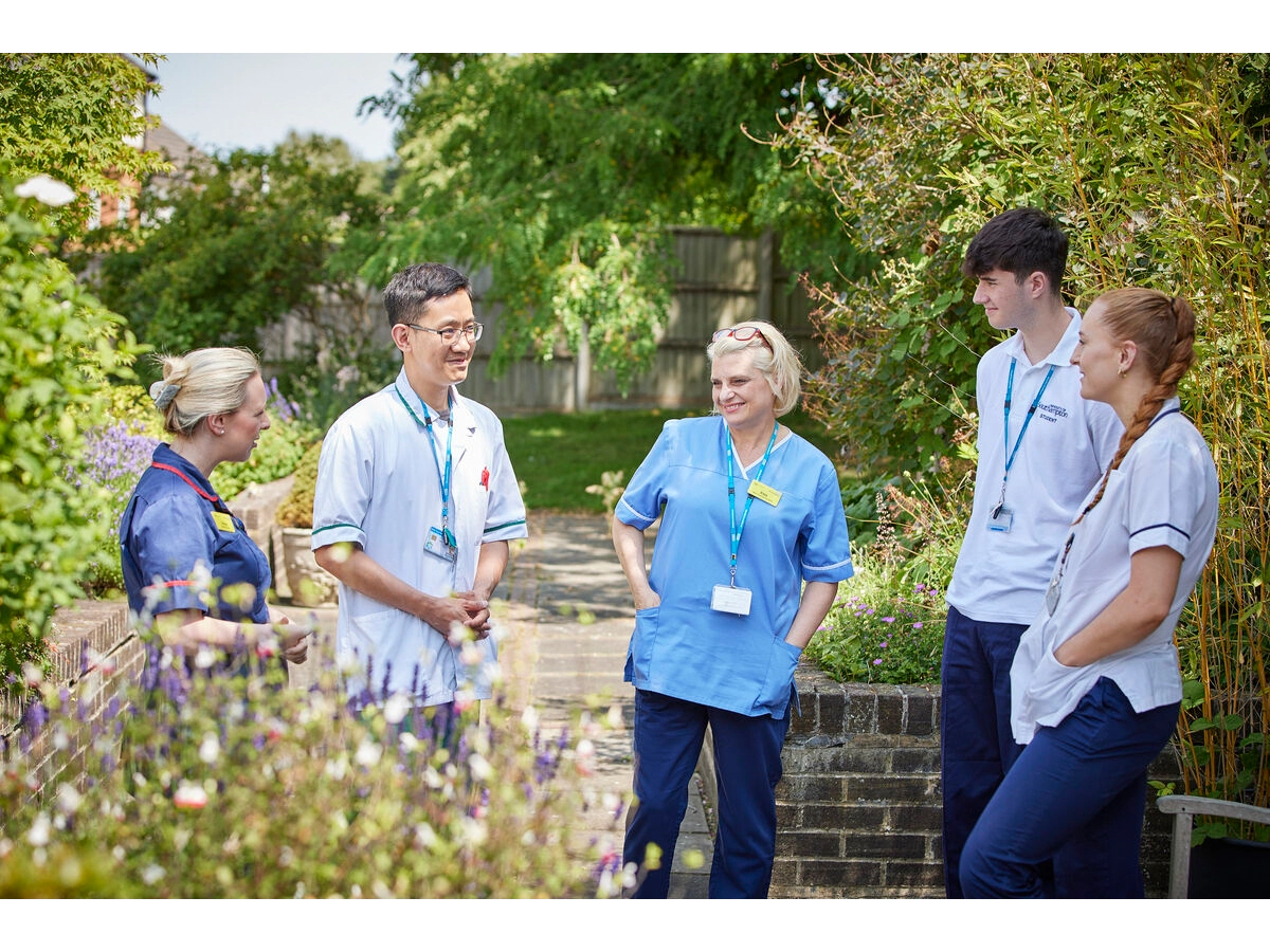 multidisciplinary team meeting outside in a courtyard