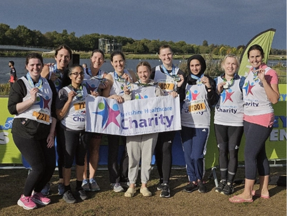 A group photo holding Berkshire Healthcare banner