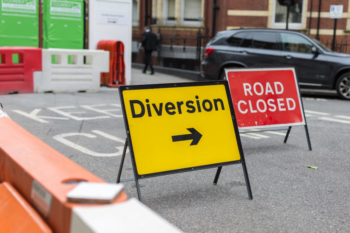 A diversion and road closed signs on a closed road