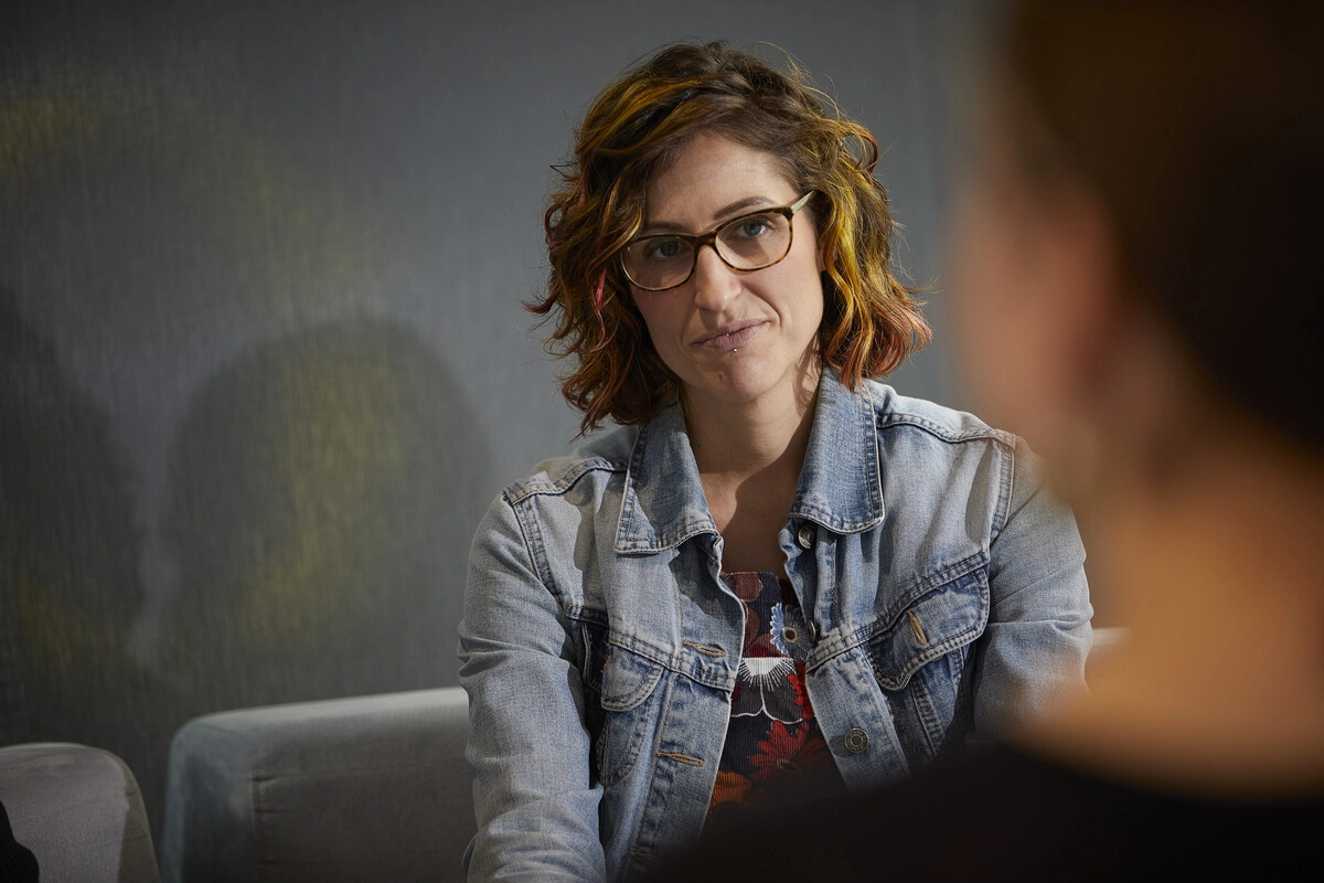 Woman talking to staff