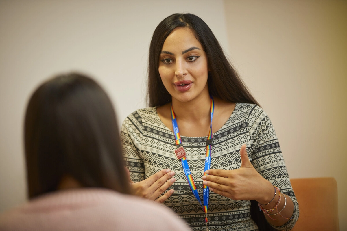 Female Therapist wearing Rainbow Lanyard in Talking Therapy