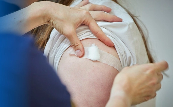 Arm with cotton bud on after a vaccine