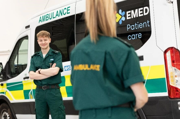Two ambulance staff standing outside ambulance