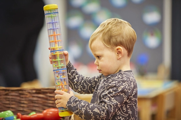Young Boy With Rain Tube Sensory Toy