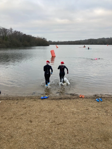 Two team members running into the lake 