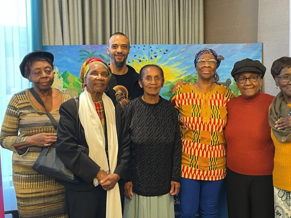 The artist Joseph Silvanos Wafula with members of the Windrush Generation and former NHS workers whose reminiscences inspired his painting.