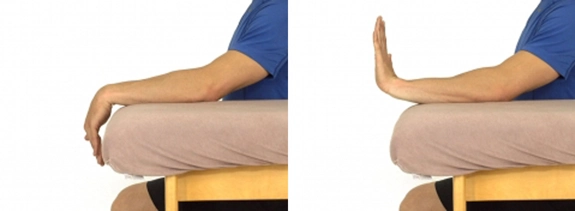 Arm resting while sat, with hand pointed down and overhanging, and then hand pointing straight up.