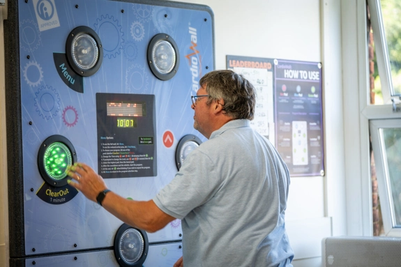 A patient using the interactive cardio wall activity on a hospital ward