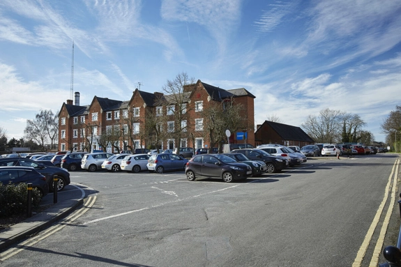 Wokingham Community Hospital with cars parked in front