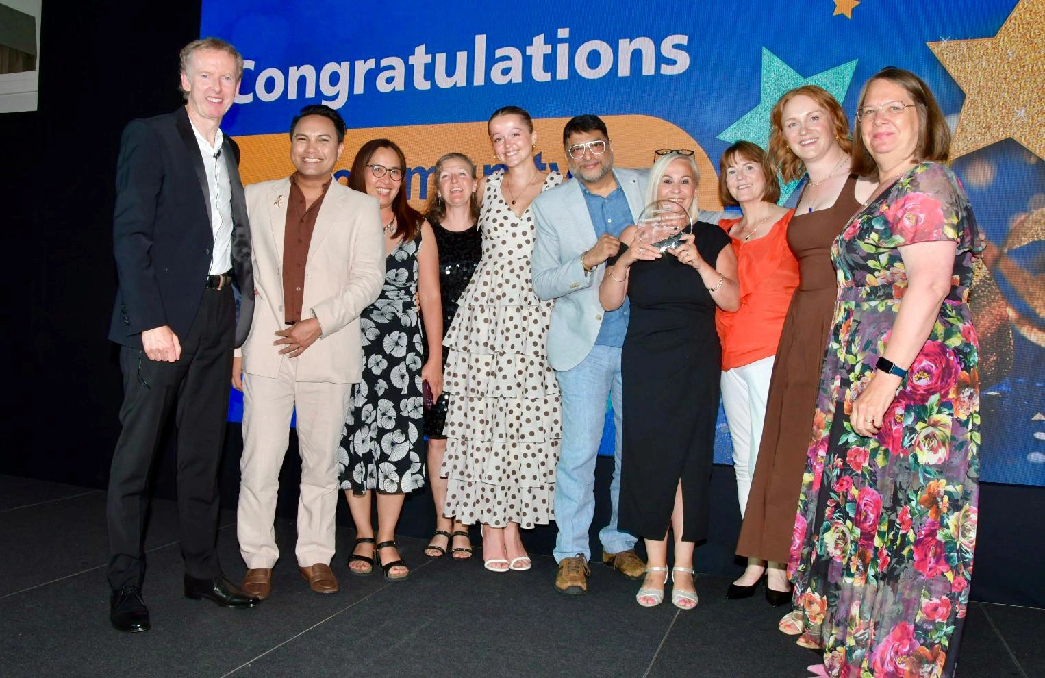 A group photograph of Julian Emms congratulating award winners
