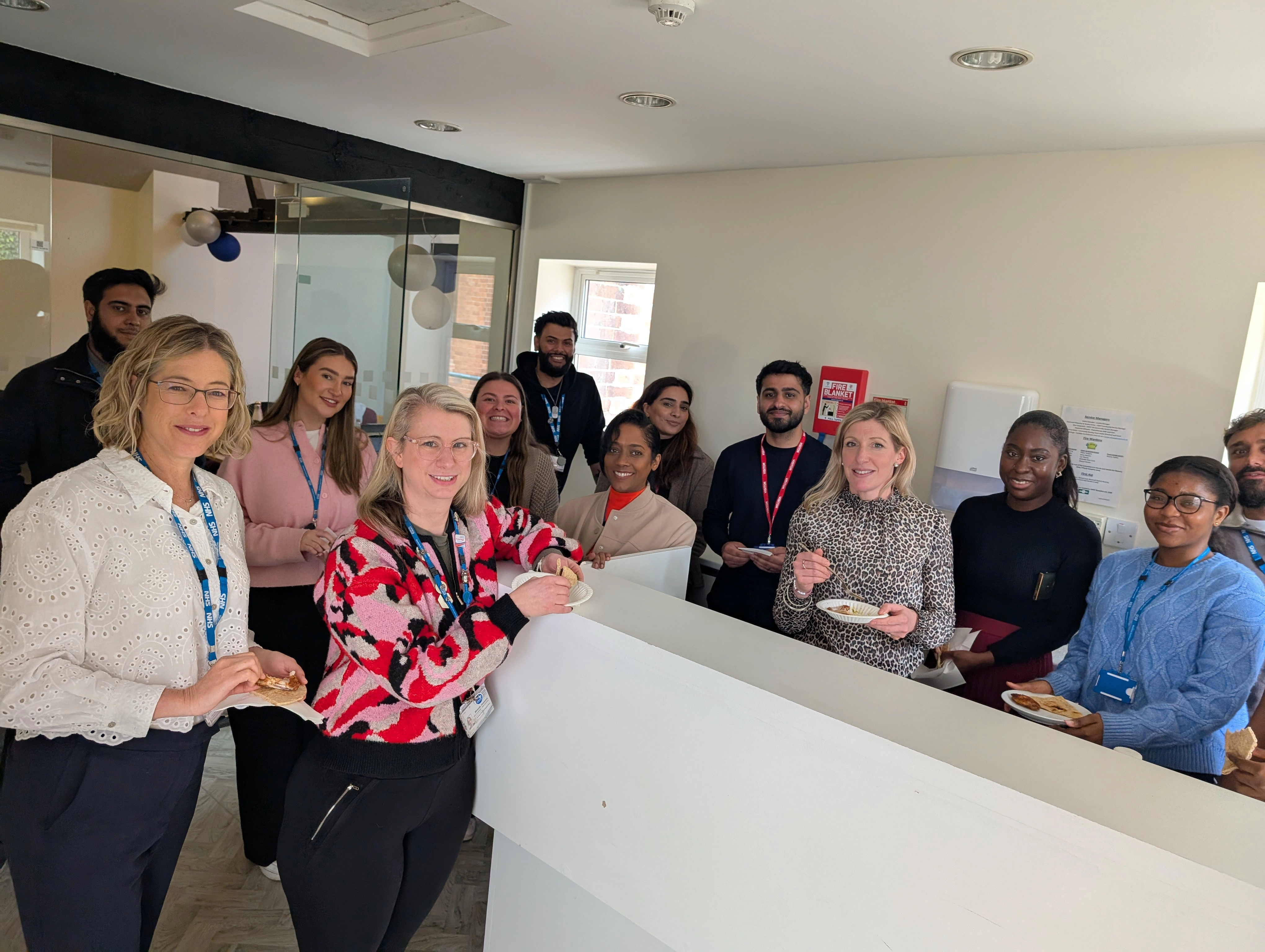 The Individual Placement Team Photo group smiling in the office