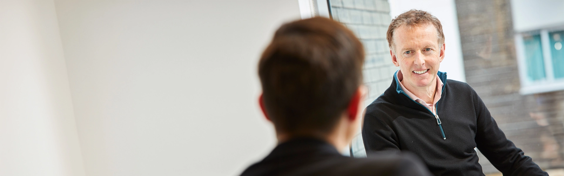 Julian Emms, CEO, talking to a colleague