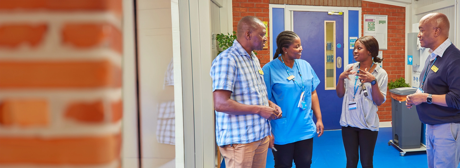 Mental health nursing colleagues talking in corridor